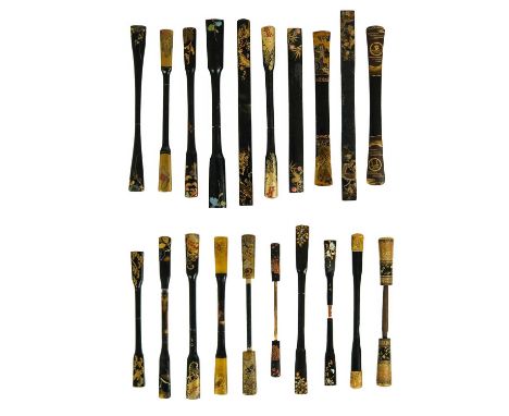 Twenty Japanese black and mainly gilt laquer kogai, 19th/20th century. Largest length 18cm. (20)From the collection of Pat Jo