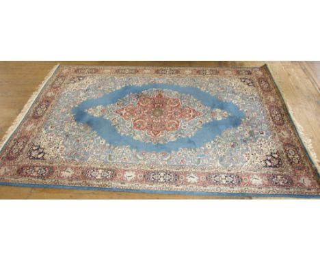 A Ladik carpet, decorated a central medallion on a light blue ground, within a multi-border, 298 x 205 cm Condition report Re