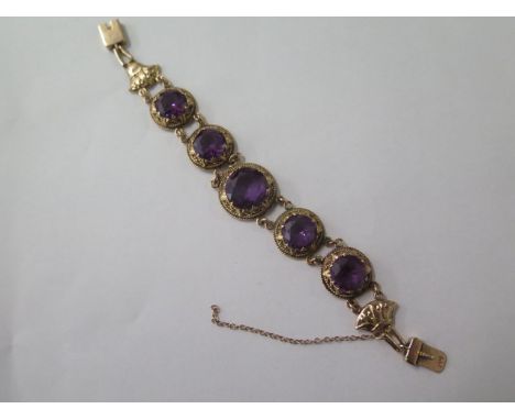 A 9ct yellow gold hallmarked amethyst bracelet, 17cm long, approx 27.8 grams, safety chain loose and some wear to stones othe