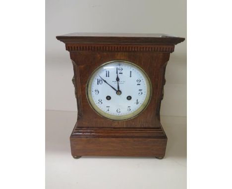 An 8 day oak case mantle clock, Maple &amp; Co, London and Paris, lion head handles, fluted corners to case, running 