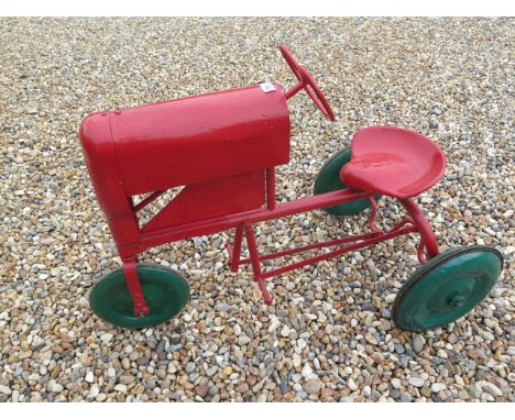 A Tri-ang 3 wheel tinplate pedal tractor, 67cm tall x 96cm long, in working order, repainted 