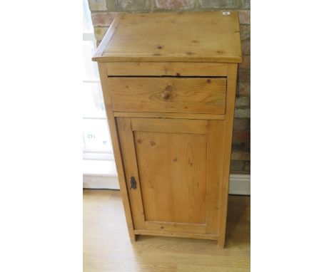 A stripped pine clerks desk / podium with a slope above a drawer and cupboard, 120cm tall x 57cm x 41cm 