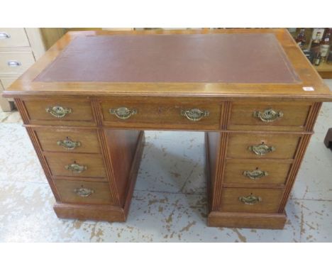 A late Victorian / Edwardian twin pedestal 9 drawer writing desk with leatherette inset top, 76cm tall x 115cm x 68cm, some g
