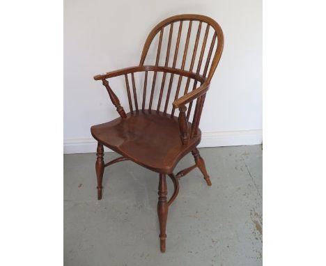 An ash and elm 19th century style Windsor stick back elbow chair with a crinolene stretcher, 92cm tall 