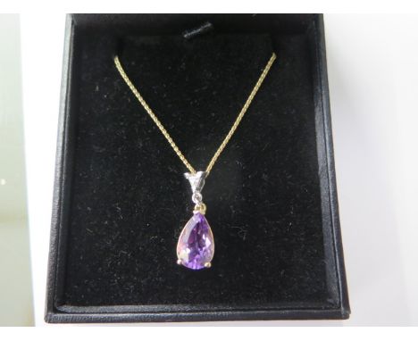An 18ct yellow gold amethyst trillion cut diamond pendant on an 18ct yellow gold chain, approx 18" long, in good condition 