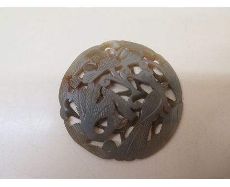 A carved jade roundal, 5.5cm diameter, in good condition 