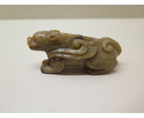 A carved jade recumbent dragon, 7cm long, in good condition 