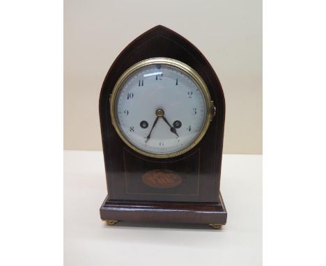 An inlaid mahogany lancet striking mantle clock, 25cm tall, generally good, small chips to dial, runs but stops 