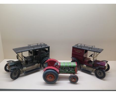 A tinplate clockwork tractor, 22cm long, and two tinplate static 