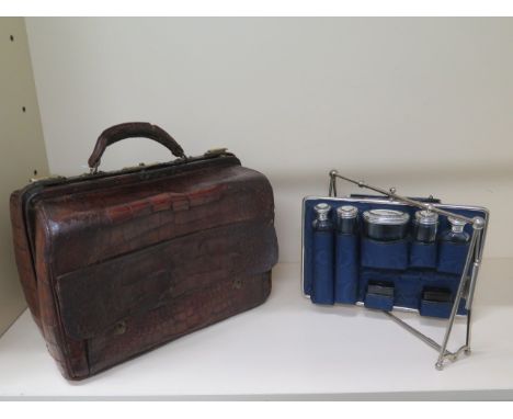 A Victorian Mappin Brothers crocodile travel case with a pullout carousel interior with 5 silver top bottles, hallmarked Lond