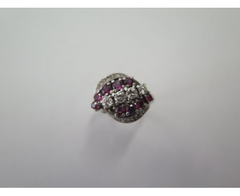 An 18ct 750 white gold diamond and ruby ring set with 4 x 3mm diamonds and 8 x 2.8mm rubies and 10 small diamonds (approx siz