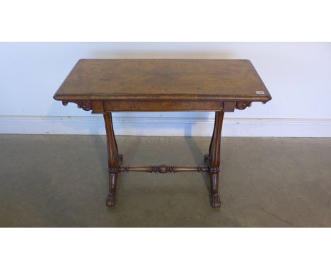 A Victorian burr walnut fold over card table on twin supports united by a turned stretcher - 91cm wide - needs some restorati