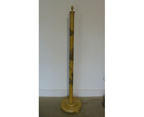A standard lamp with decorative relief oriental scenes upon its column, approx 162cm overall, without its shade but in good c