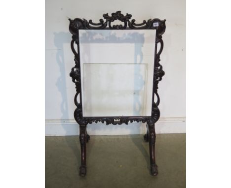 A good quality 19th century carved mahogany firescreen on scroll supports - 107cm tall x 61cm W, some restoration needed, top