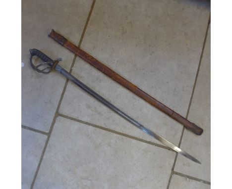 A Royal Artillery Officers sword by Joseph Lyons Woolwich with leather scabbard, blade length 84cm - some small pitting to bl