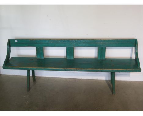 A Vintage painted bench in old green paint, mounted on hand cut legs, woodworm treated - 184cm long, 72cm tall 