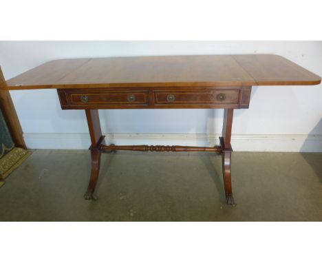 A yew wood drop leaf sofa table, with two active and two dummy drawers, in sound condition, some discolouring to veneer 