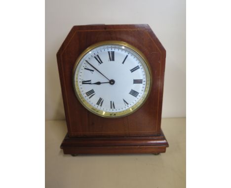 An 8 day platform movement mantle clock, mahogany case on brass bun feet, condition - working with key 