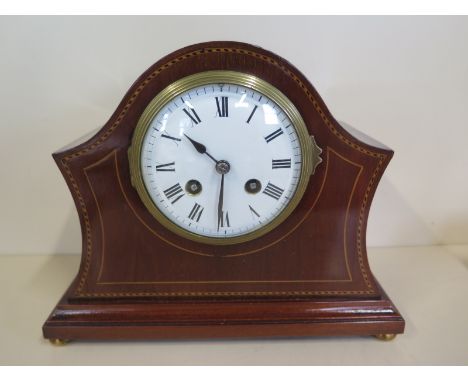 An inlaid mahogany mantle clock with an enamel dial striking on a gong 
