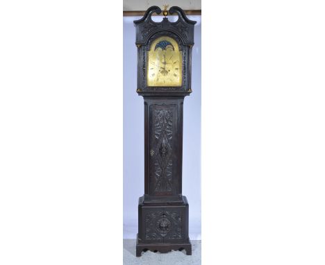 Oak longcase clock, the hood with swan neck pediment, fluted columns, long door bracket feet, all over carved decoration, arc