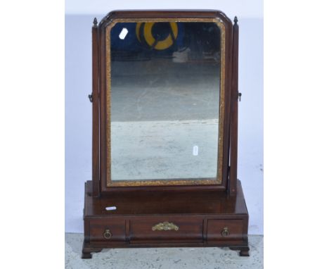 An Edwardian mahogany rectangular swing toilet mirror, the rectangular base having three concave drawers all supported on cor