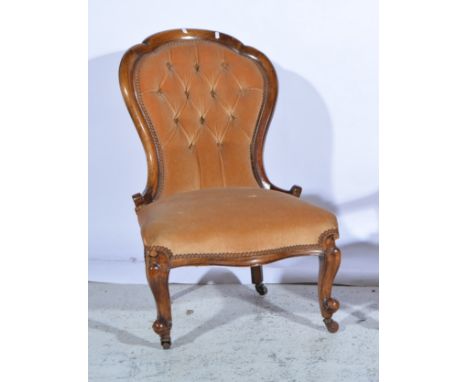 A ladies mahogany framed button back chair, cabriole legs with castors, upholstered in a beige velvet, 