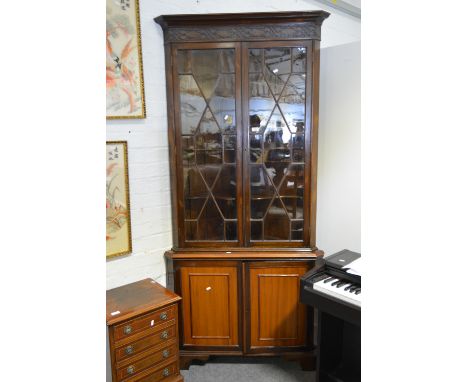 Mahogany freestanding corner cabinet, 19th century with adaptions, cavetto cornice with a blind fretwork frieze, two astragal