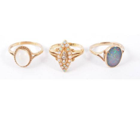 Three opal set rings, (3)