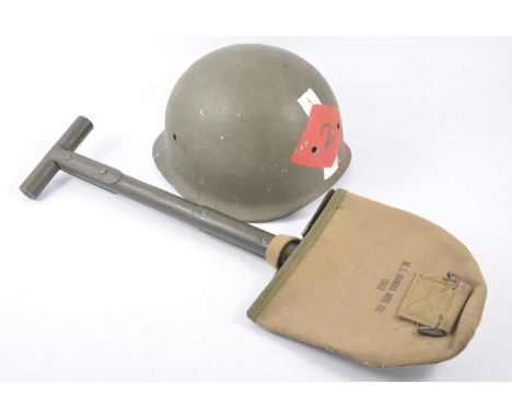An American pattern helmet, no liner, hand painted and two reproduction US WW2 Military issue spades.