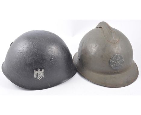 German pattern helmet with Eagle and SS Insignia, leather lined, and another foreign metal helmet.