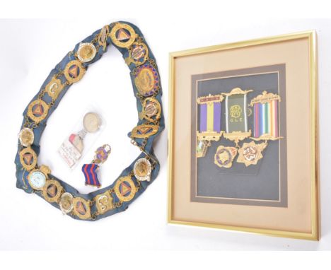 Gilt metal Masonic pendant, sash with attached badges and three framed Masonic badges.