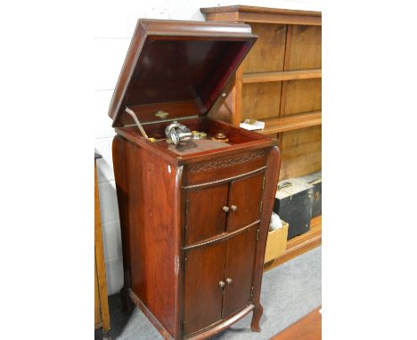 Vintage gramophone cabinet, with a selection of records.