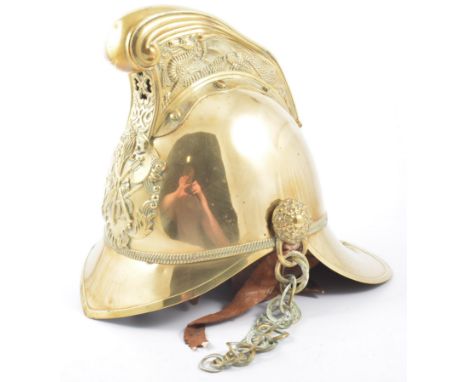 Brass fireman's helmet, leather liner and chin chain, height 27cm.