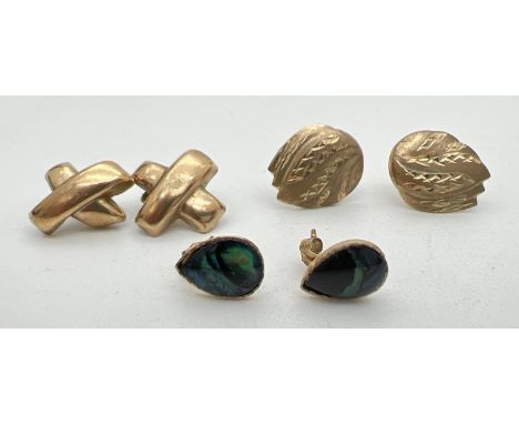 3 pairs of vintage yellow metal earrings in stud styles. A teardrop shaped pair set with black onyx, a leaf design pair and a