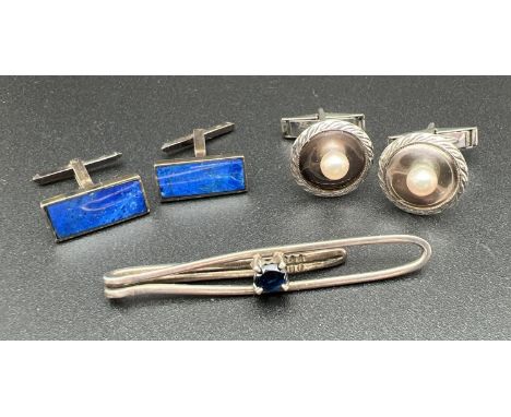 2 pairs of vintage silver cuff links together with a silver tie clip set with a central oval cut sapphire. A circular pair of