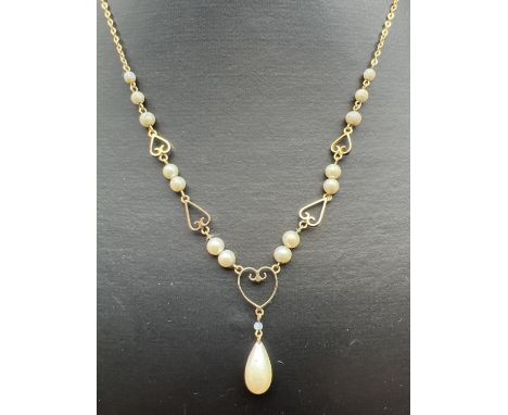 A vintage 9ct gold faux pearl and open heart link fixed drop pendant necklace. Belcher style chain with graduating sized smal