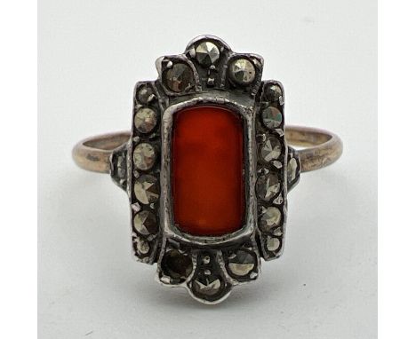 A vintage 9ct gold Art Deco design dress ring set with a rectangular cut carnelian stone surrounded by marcasite stones (one 
