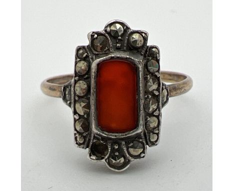 A vintage 9ct gold Art Deco design dress ring set with a rectangular cut carnelian stone surrounded by marcasite stones (one 