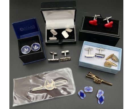 A collection of boxed and unboxed cuff links and tie clips in various styles and designs. To include silver cuff links with e