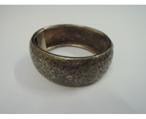 A Victorian silver hinged bangle having foliate engraved decoration, Birmingham 1893