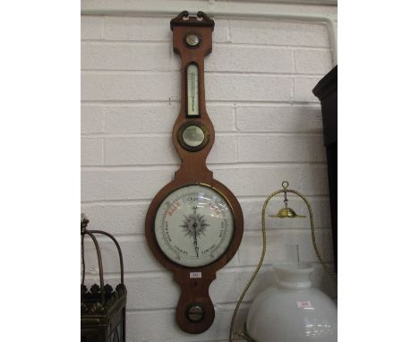 A late 19th century mahogany case wheel barometer having thermometer scale