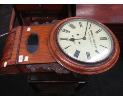 An early 20th century walnut framed wall clock having Roman numeral face, by Camerer Kuss & Co London