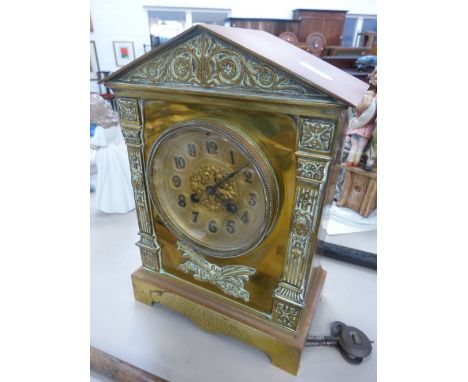 An Edwardian brass mantel clock of architectural pediment style having engraving for Golden Wedding 1903