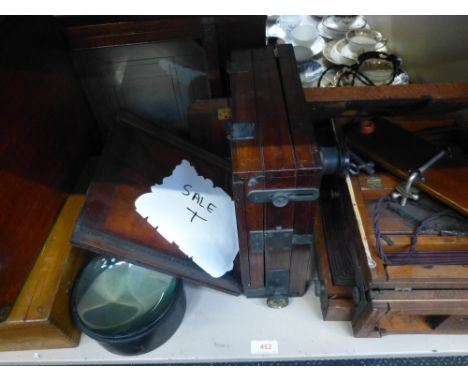 A vintage mahogany plate camera and developer including glass portrait negatives