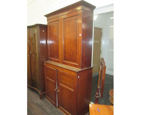 A 19th century oak linen press/housekeeper cupboard having crossband and panel decoration