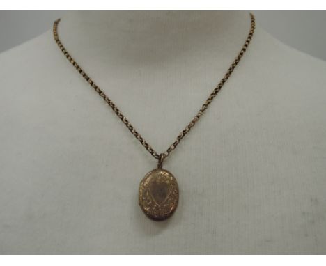 An oval yellow metal locket on a 16' belcher chain stamped 9ct