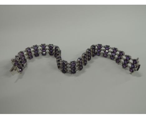 A white metal triple row amethyst bracelet stamped 925
