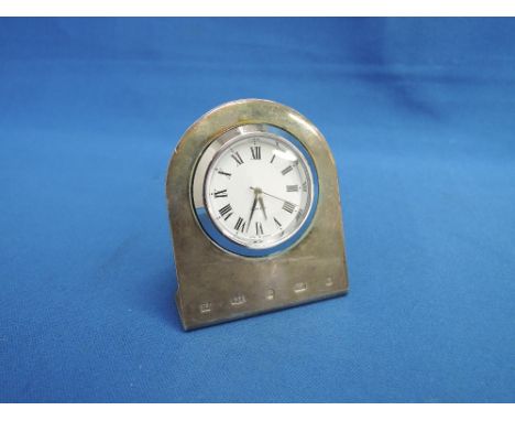 A miniature clock having a Roman numeral dial in a silver arched stand, Birmingham 2001, makers mark TP