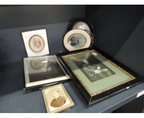 A selection of vintage photograph frames of family portrait interest