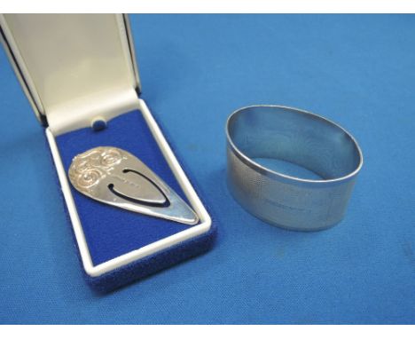 A silver bookmark having moulded decoration, Birmingham 1994, Harman Brothers, and an HM silver napkin ring having engine tur